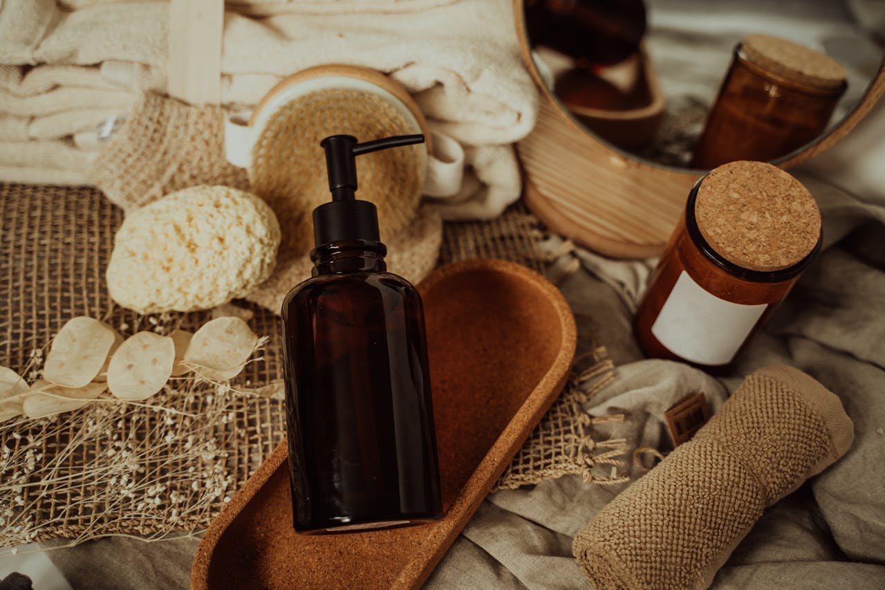 about-us Elegant amber glass bottle with pump, surrounded by natural materials. Ideal for skincare products.